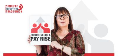 ETUC Deputy General Secretary Esther Lynch holding a sign saying: Europe needs a pay rise