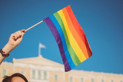 Person waving a rainbow flag.