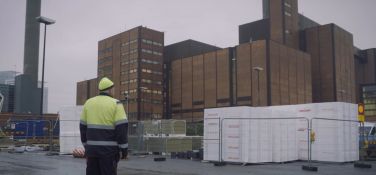 Worker looks on at closed electricity plant