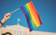 Person waving a rainbow flag.